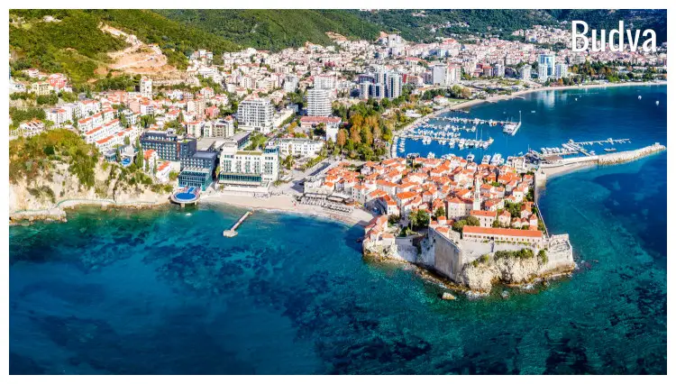 The seaside city of Budva in Montenegro, with the beautiful waterfront promenade and hilly slopes The seaside city of Budva in Montenegro, with the beautiful waterfront promenade and hilly slopes